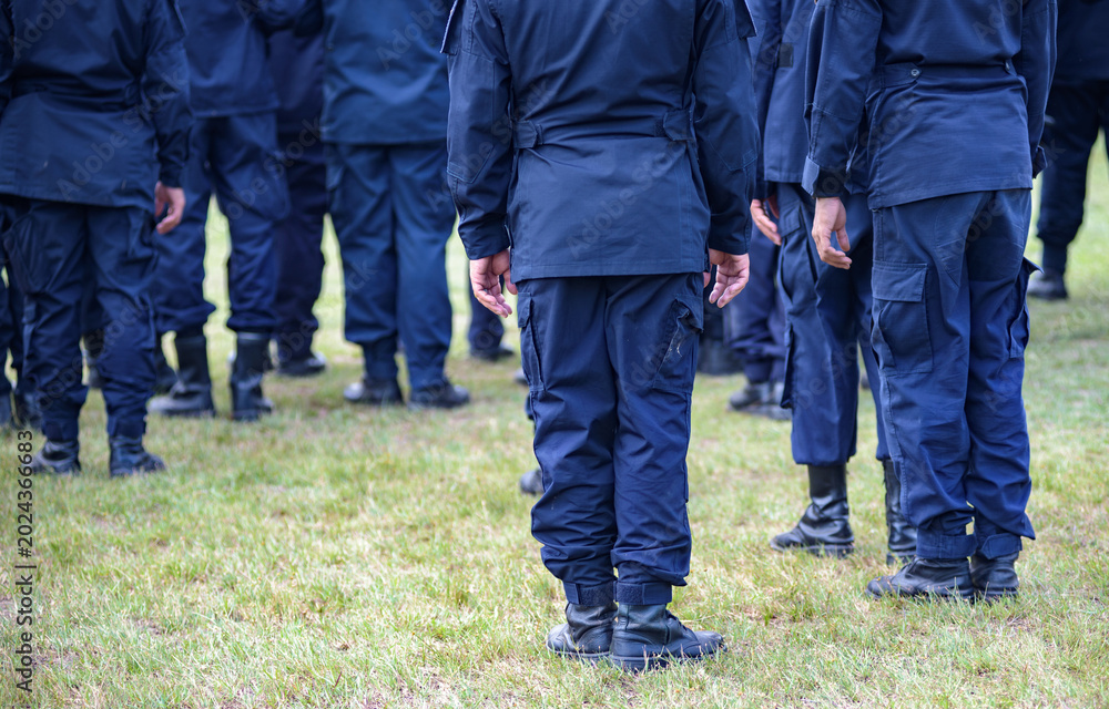 Fototapeta premium Riot police control the crowd practice and review on the grass field.