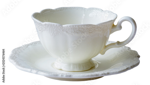 Fotografía Elegant white porcelain teacup with ornate rim and handle resting on saucer, iso
