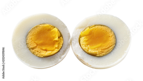 Fotografie Two halves of a hard-boiled egg showing white albumen and yellow yolk, isolated