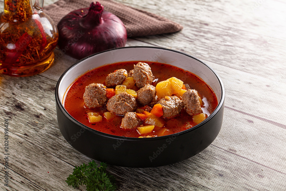 Fototapeta premium Tomato soup with meatballs and vegetables