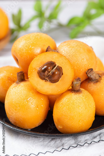 Bilde på lerret ripe loquat fruit on wooden table.