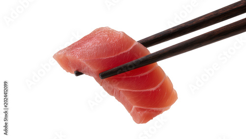 Obraz na płótnie Raw tuna sashimi slice held by dark wooden chopsticks, isolated on transparent b
