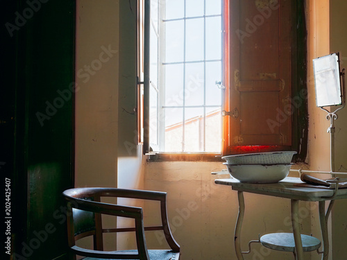 Vintage wash basin and mirror inside abandoned historic villa room