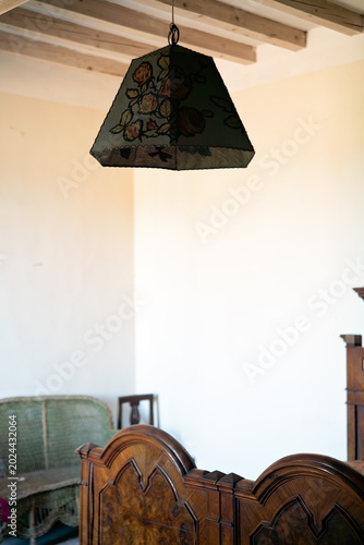 Abandoned Bedroom Interior with Vintage Lamp and Wooden Beams – Urbex Scene
