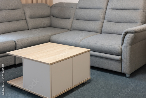 Textile gray sofa set with wooden table. Horizontally.