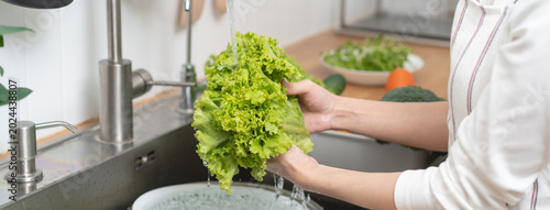 Tableau sur toile people washing raw vegetables at sink in the kitchen prepare ingredient for cook