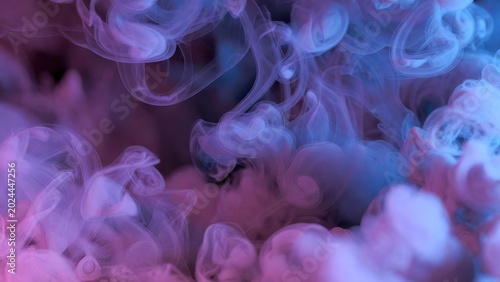 Abstract smoke swirls in vibrant purple and blue hues for creative backgrounds