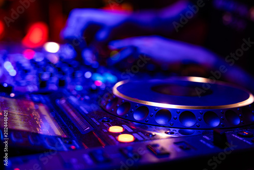 Fotografie Professional dj mixer controller with lights at nightclub party close up