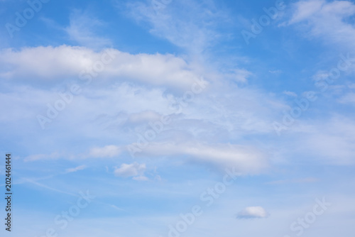 Fotografie Soft white clouds stretching across the vibrant blue sky creating a beautiful natural texture