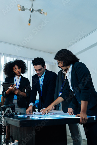 Diverse group of professional business people having a serious meeting and analyzing documents on a table in a modern office. Team of corporate experts collaborating on a new strategic project