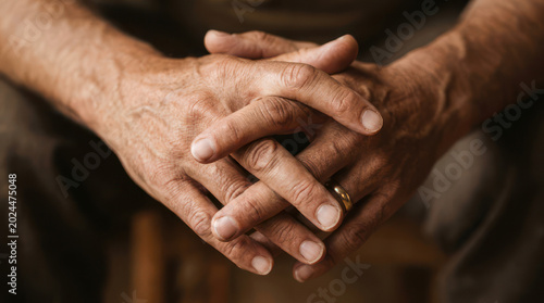 Closeup of Interlocked Hands Showing Age and Experience.