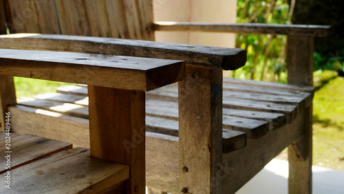 Obraz na płótnie Rustic wooden bench with natural grain texture basking in warm sunlight outdoors