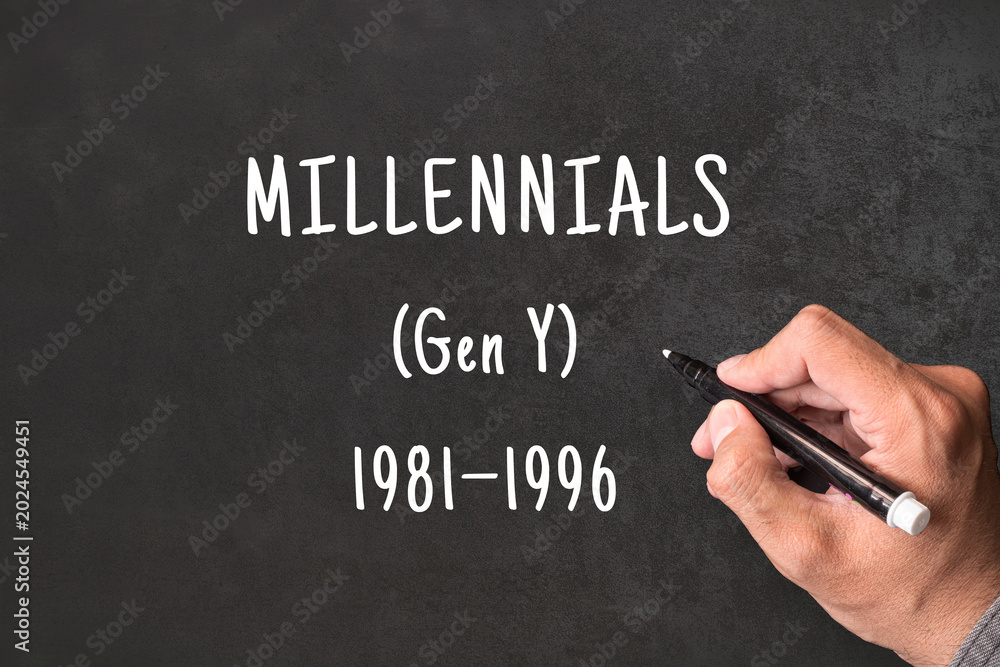 Fototapeta premium Millennials written on blackboard with hand, Gen Y born 1981 to 1996, generational demographics and social research concept