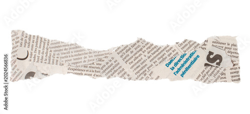 Fotografie Torn newspaper clipping with French text