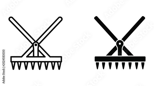 Foto Two garden rake tools in crossed position