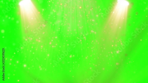 Vibrant green background with sparkling particles and bright spotlights shining down