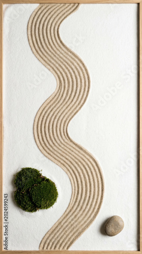 Zen garden with raked sand pattern and stones