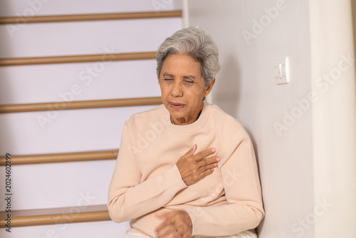 Cuadro en lienzo Elderly senior woman experiencing severe pain in chest from sudden heart attack