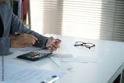 Photos An accountant reviews receipts