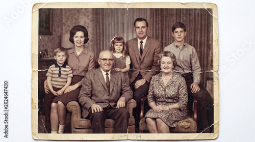 Vintage family photo with multiple generations sitting together  
