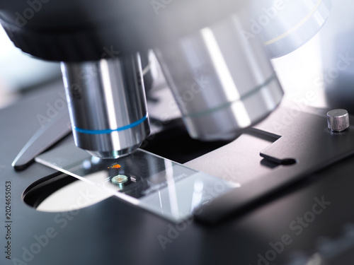 Close-up of microscope testing blood sample in laboratory