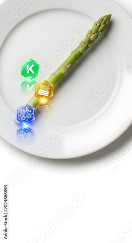 Green asparagus spear with vitamin letter blocks K, B, D on white plate for healthy nutrition and wellness concept