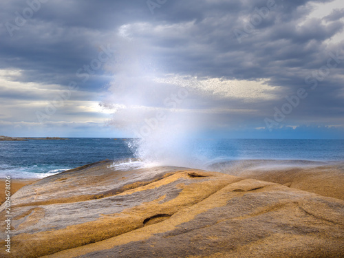 Photos Bicheno blowhole (marine geyser) surrounded by stunning lichen-covered granite b