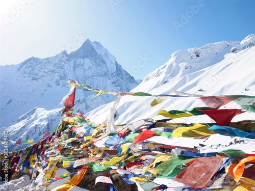 Cuadro en lienzo Stunning view of snow-capped mountains in the Himalayas with colorful Tibetan prayer flags fluttering in the wind under a clear blue sky