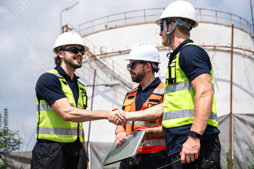 Industrial Engineers Handshake During Petroleum Refinery Inspection At Petrochemical Energy Infrastructure Facility