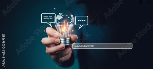 Hand holding glowing light bulb with cloud and chat icons and command prompt.