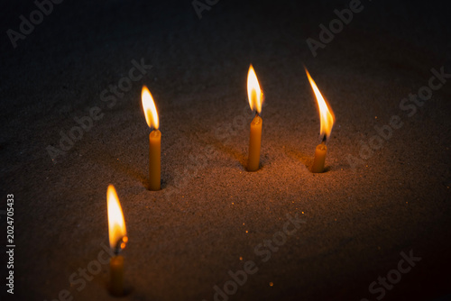 Foto Prayer candles burning in the sand