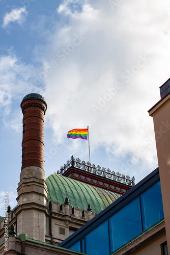 Rainbow flag flutters on an ancient building in the city