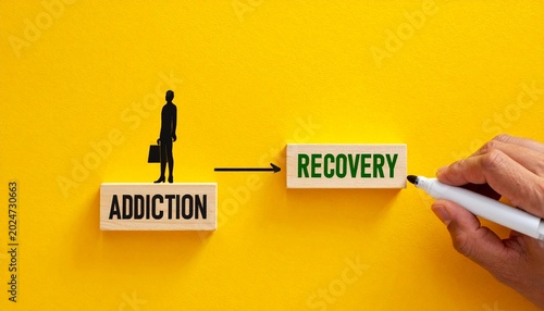 Addiction to recovery concept, wooden blocks connected by drawn line on yellow background