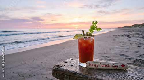 Caesar cocktail on a beach at sunset for canada day celebration with cocktail