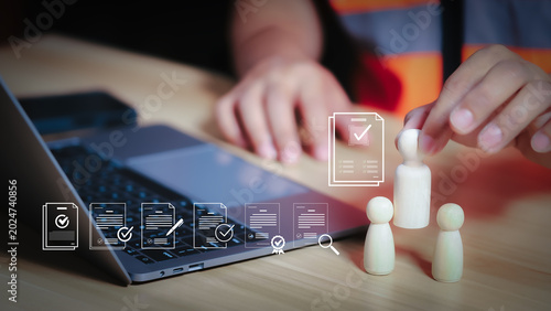 Foto HR manager selecting qualified engineer worker from wooden peg dolls on laptop background for industrial recruitment concept