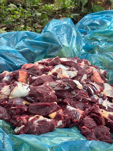 Close-up photo of raw beef meat from cattle placed on a clean surface with natural texture and rich red color. Fresh uncooked meat suitable for food industry, butcher shop, protein nutrition, culinary