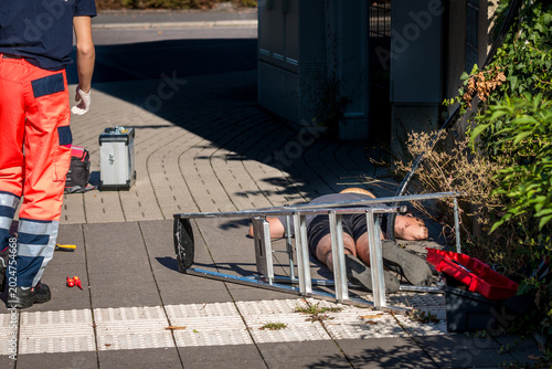 Photos Man lying on ground after electric shock accident with ladder and cable