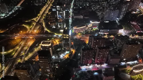 Illuminated city skyline and highway interchange at night