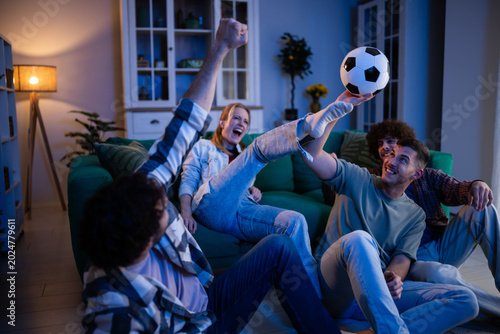 Photos Friends cheering and celebrating while watching soccer game