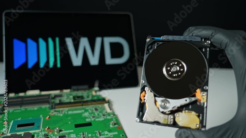Display of the HDD hard drive for cloud data storage with Western Digital background. WD world's largest manufacturers of Hard Disk Drives and SSD memory
