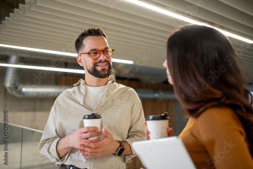 Photos Colleagues having coffee break and casual conversation in office