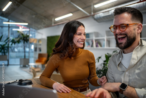Bild auf Leinwand Colleagues sharing a happy moment laughing together at office