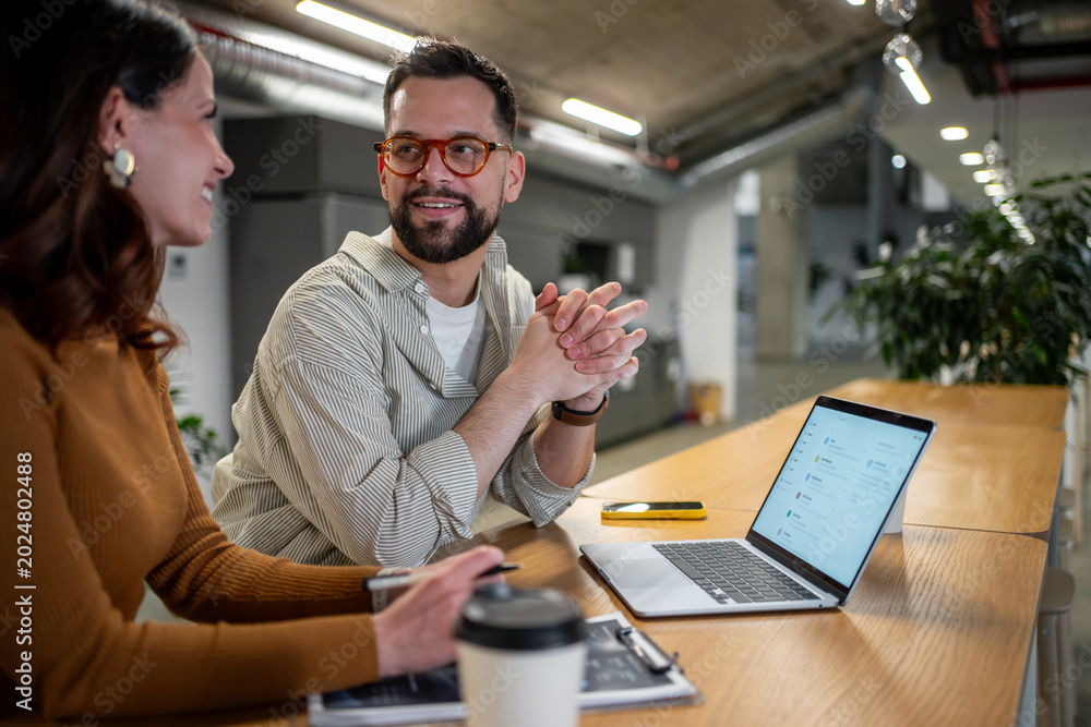 Fototapeta premium Colleagues collaborating on business project at modern coworking office