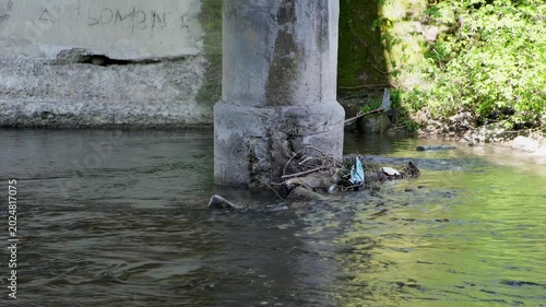 Concrete Bridge Support Pillar in Fast Flowing River Water