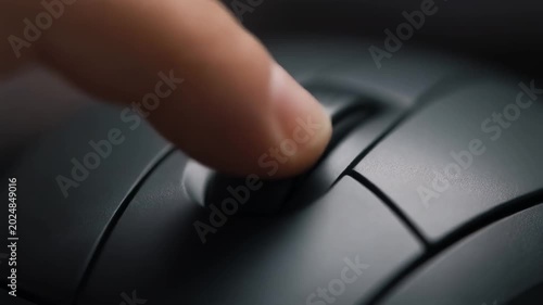 Close-up of a finger pressing a computer mouse button, shallow depth of field, soft lighting