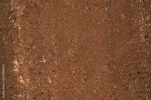 Dry brown soil with a tilled, granular texture photographed from above, ideal for agriculture, gardening and background use