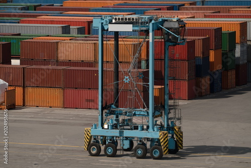 Container straddle carrier in shipping port yard