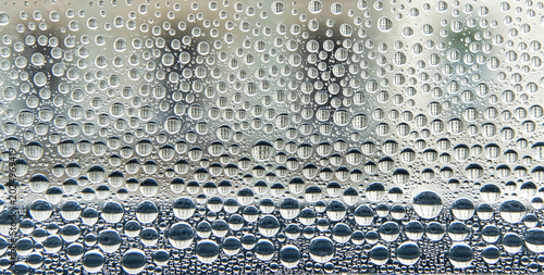 Photos Fascinating surface tension: Countless condensation droplets on a window pane, each reflecting the geometric patterns of urban architecture