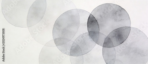 The image features a minimalist abstract design with overlapping translucent circles on a white background.