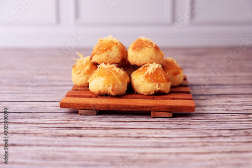 Konstfotografi Kue Nastar or Golden pastries rest on a wooden board